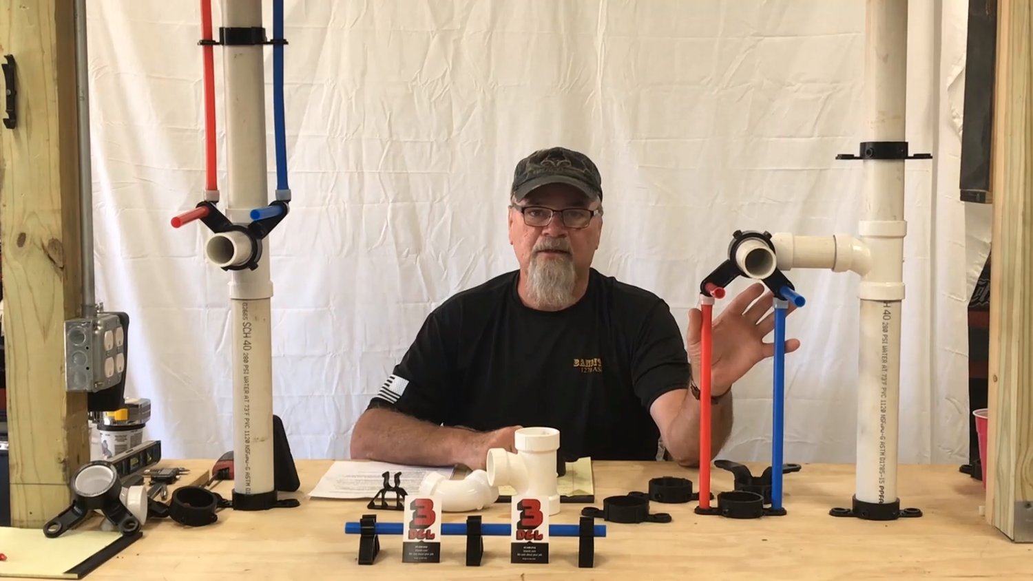 3D&L owner Doug Harris demonstrates the company’s products that hold pipes in place.
